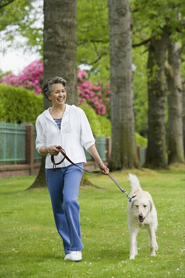 African American woman walking dog