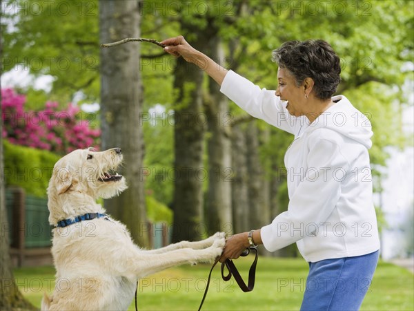 African American woman playing with dog