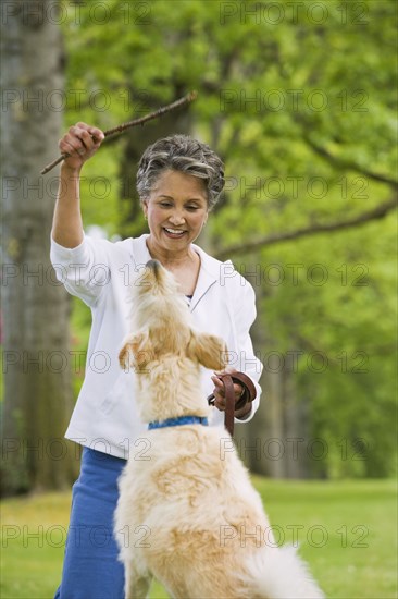 African American woman playing with dog