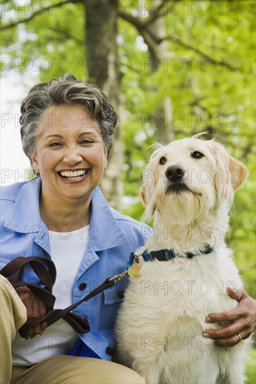 African American woman hugging dog