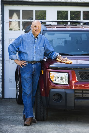 Senior African American man polishing car