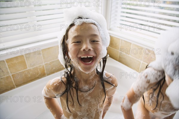 Asian sisters in bubble bath