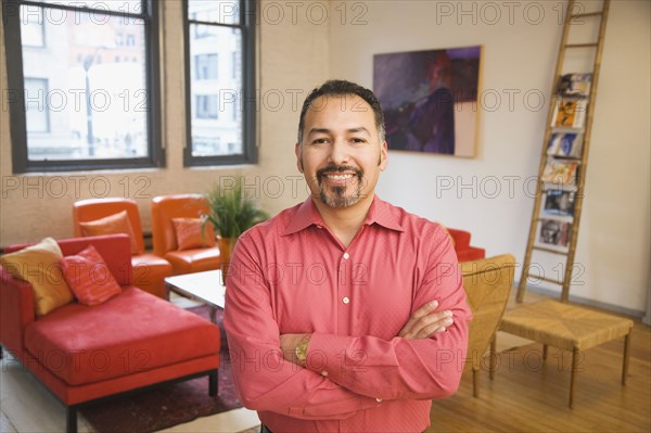 Hispanic man with arms crossed