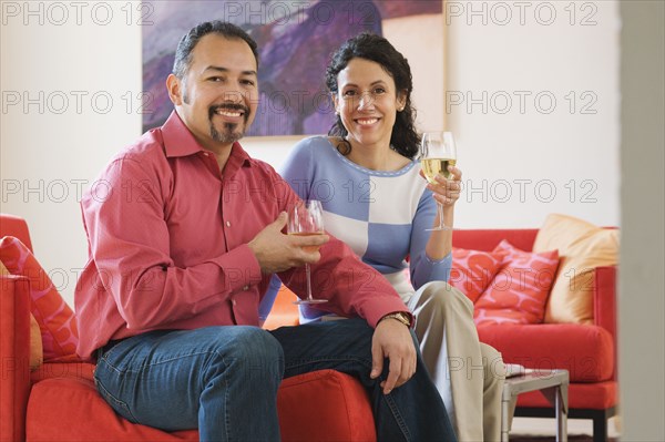 Hispanic couple drinking wine