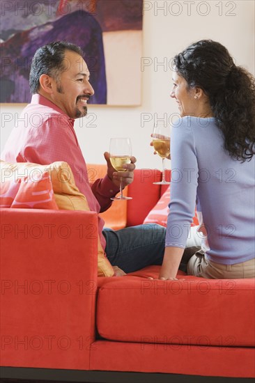 Hispanic couple drinking wine