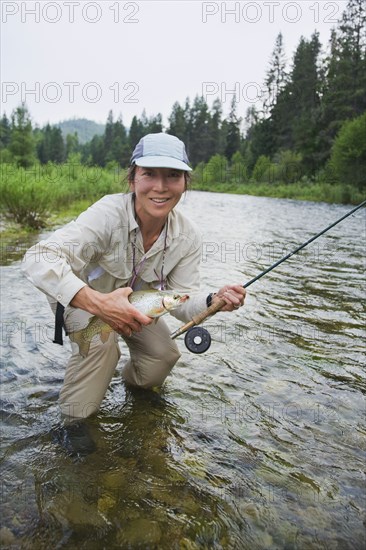 Asian woman fly fishing