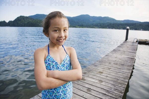 Asian girl standing on dock