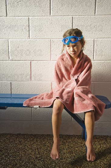 Sad Asian girl in towel and goggles