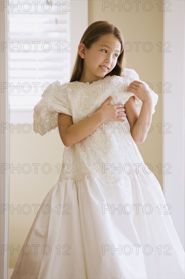 Asian girl trying on wedding dress