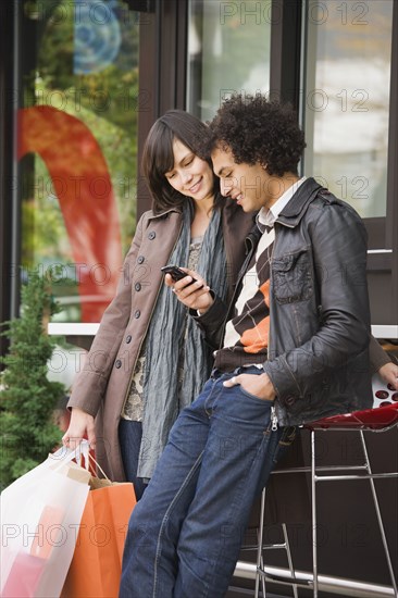 Couple text messaging on cell phone