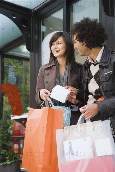 Couple with merchandise and shopping bags