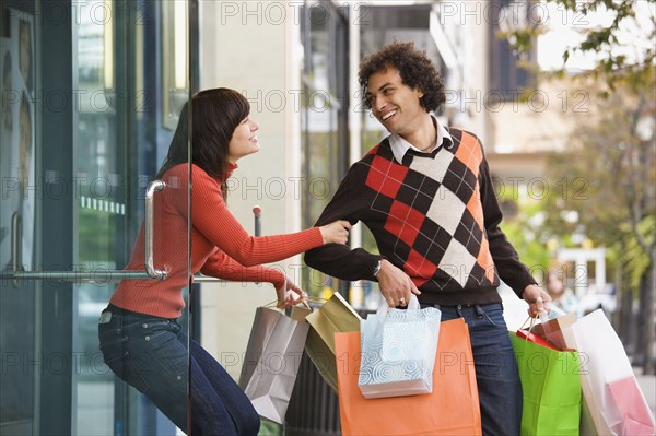 Woman trying to pull boyfriend back into store