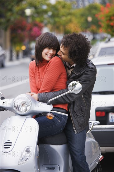 Couple sitting on scooter