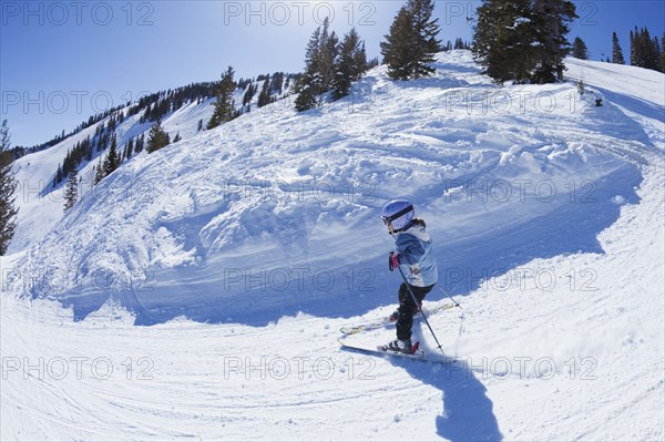 Mixed race girl skiing downhill