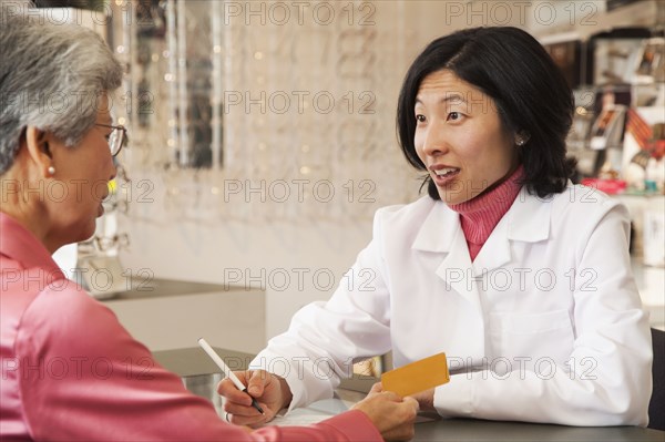 Korean optician talking to customer