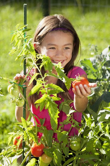 Mixed race girl gardening