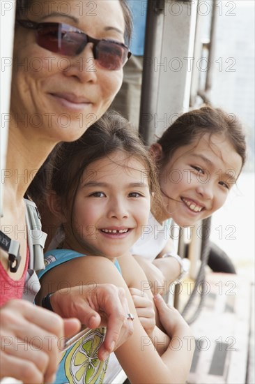 Mother and daughters riding on boat