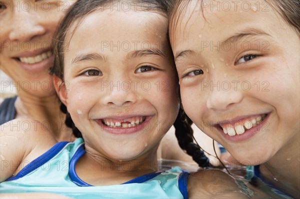 Family in pool smiling