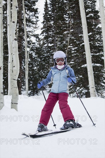 Mixed race girl skiing in woods