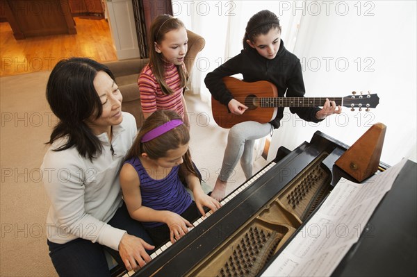 Students and teacher playing instruments