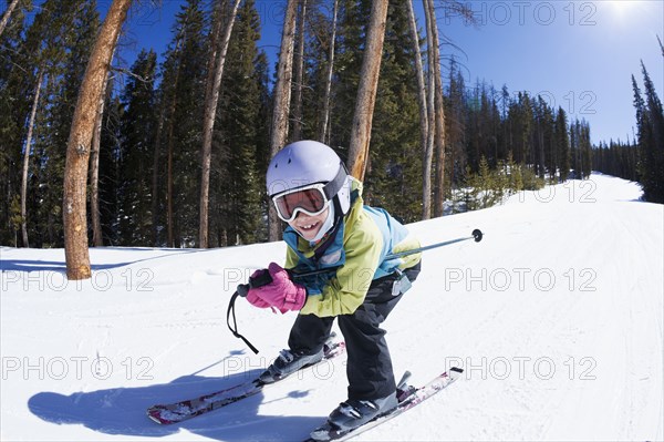 Mixed race girl skiing downhill