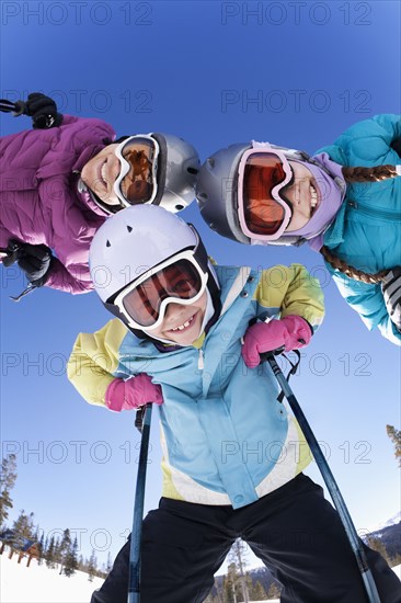 Grinning family skiing together