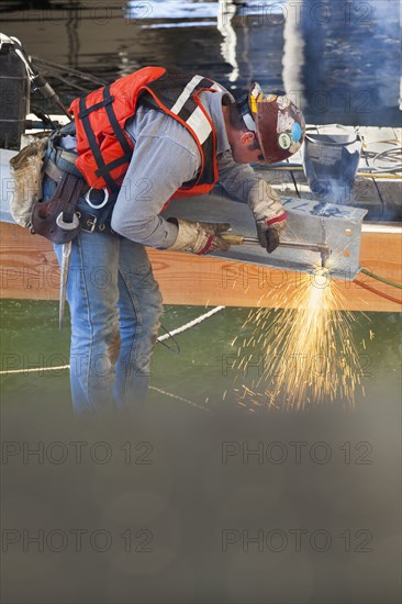 Caucasian worker welding on construction site