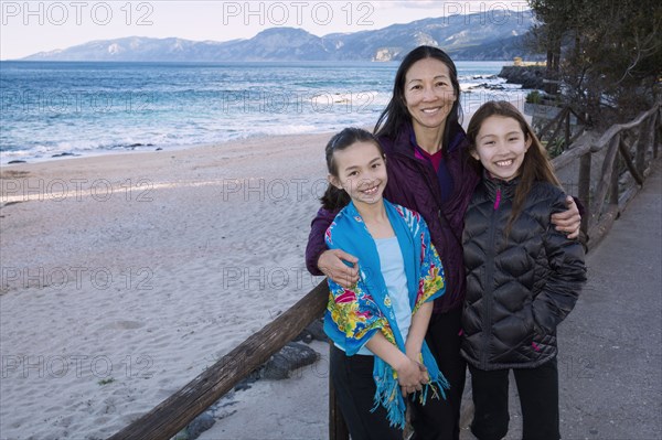 Japanese family standing on beach