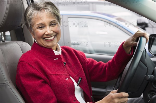 Mixed race woman driving in car