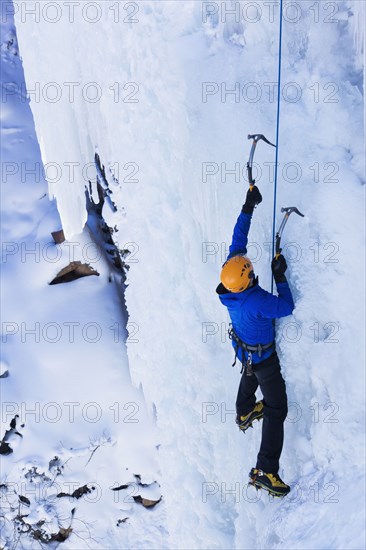 Caucasian climber scaling glacier