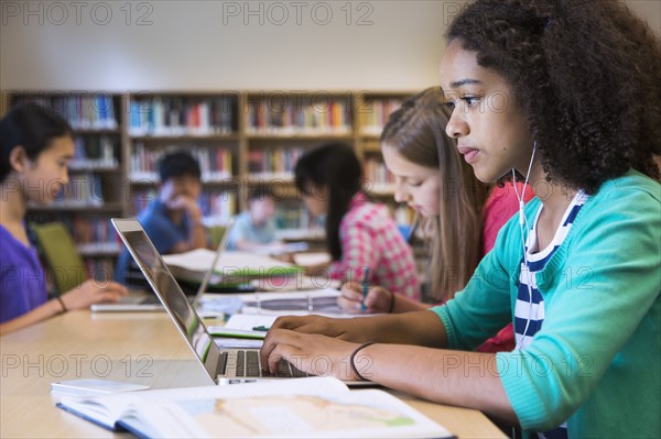 Student using laptop in library