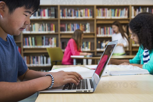 Student using laptop in library