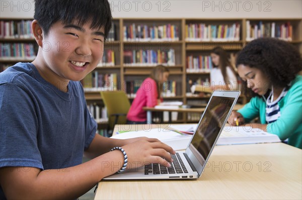 Student using laptop in library