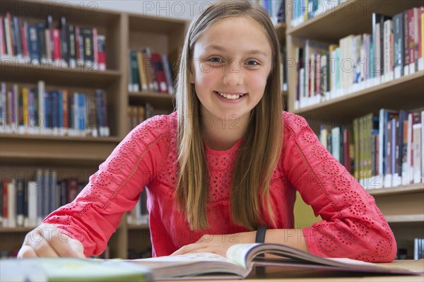 Caucasian student smiling in library