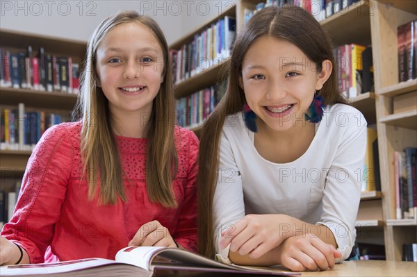 Female students smiling in library