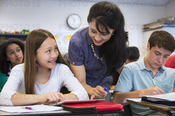 Teacher helping students in class