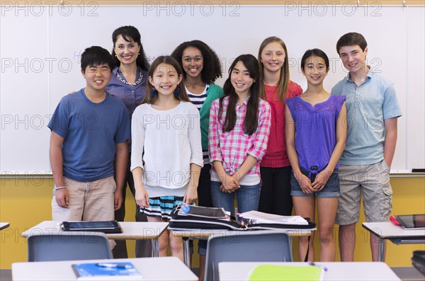 Teacher and students smiling in classroom