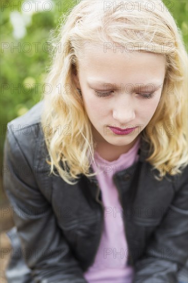 Caucasian girl sitting outdoors