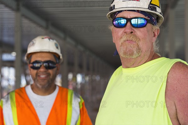 Workers smiling together at construction site