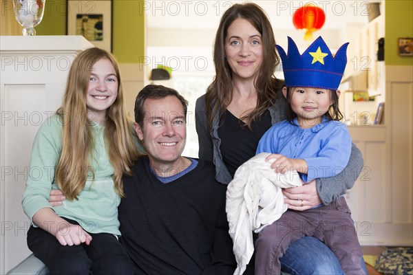 Family smiling together in living room