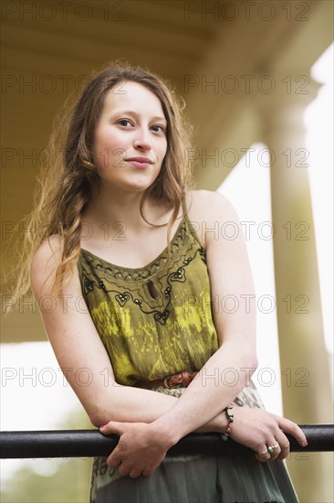 Caucasian teenage girl leaning on banister