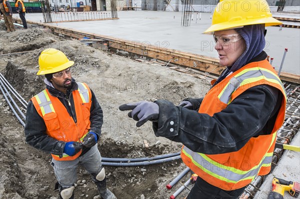 Workers talking at construction site