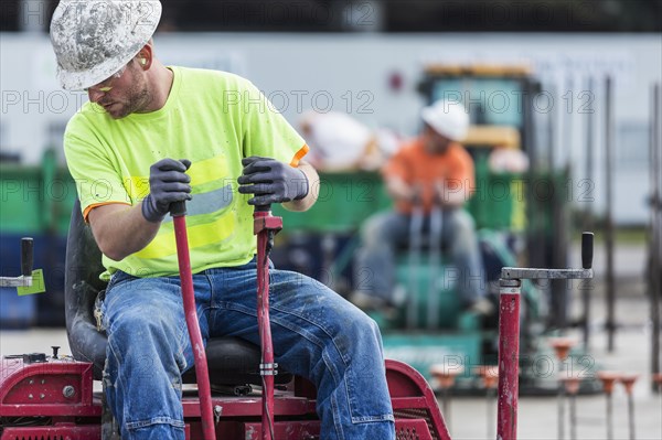 Worker operating machinery on construction site