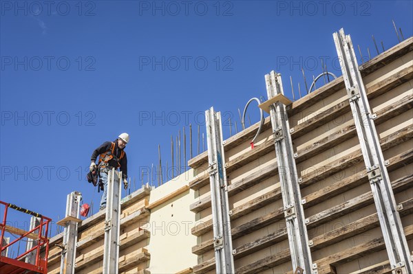 Caucasian worker walking on concrete wall form