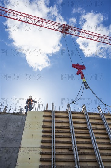 Caucasian worker walking on concrete wall form