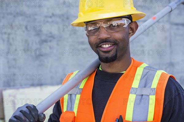 Black worker smiling on construction site