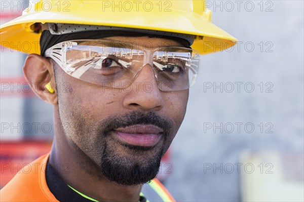 Black worker smiling on construction site