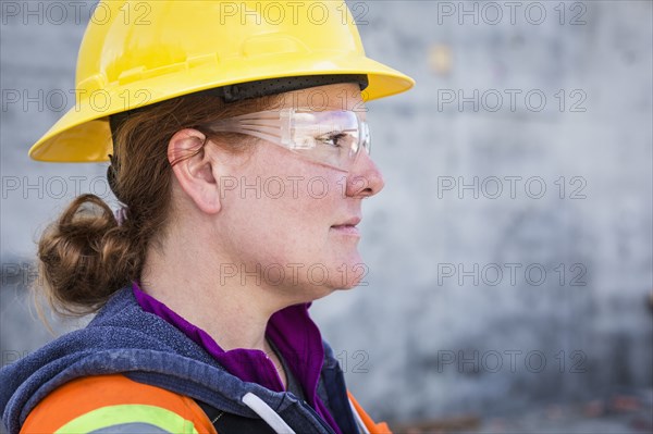 Caucasian worker wearing safety goggles on site