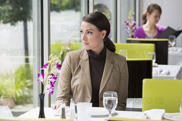 Caucasian businesswoman sitting in restaurant