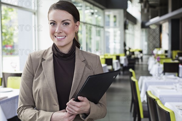 Caucasian businesswoman standing in restaurant